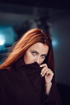 Red-haired girl in the subway, red coatの写真素材