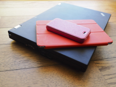laptop, phone and tablet pc on wooden deskの写真素材