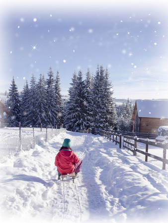 Girl on sledge in winter snow. Winter sport holidayの写真素材