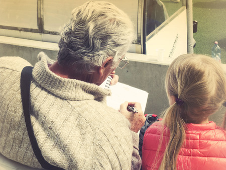 Happy little girl with grandfatherの写真素材