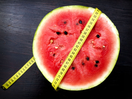 Measuring tape and watermelon, diet conceptの写真素材