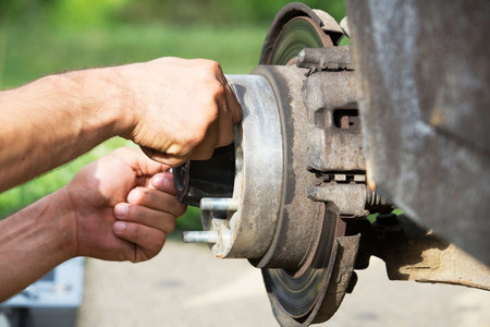 Man fixing a car wheelの写真素材