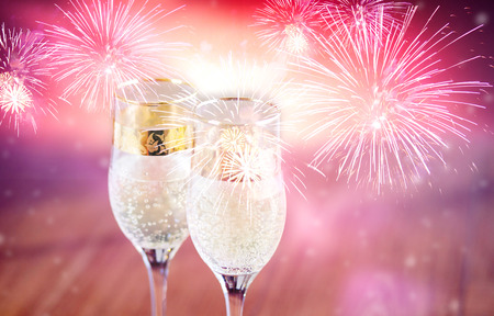 Champagne glasses and fireworks. New Year backgroundの写真素材