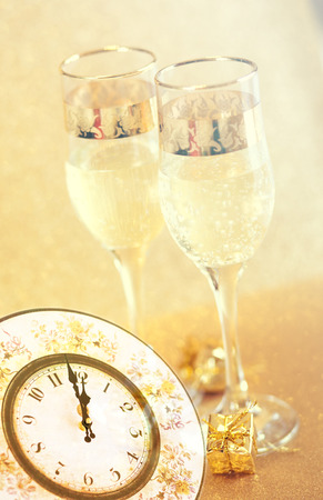 Champagne glasses and midnight clock. Happy New Yearの写真素材