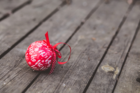 Red Christmas ball decoration on rustic wood backgroundの写真素材
