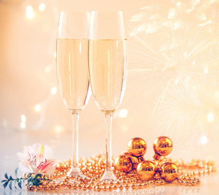New Year Champagne glasses and fireworks backgroundの写真素材