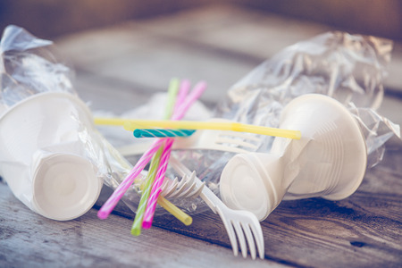 Plastic pollution on wooden backgroundの写真素材