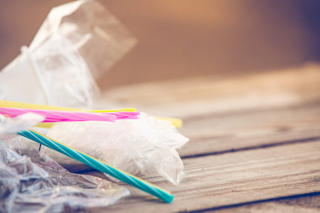 Plastic pollution on wooden background