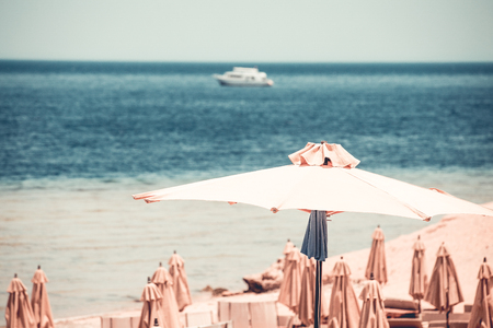 Relaxing Beach background with umbrellas and seaの写真素材