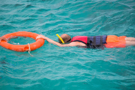 Snorkeling tourist in clear blue water paradise