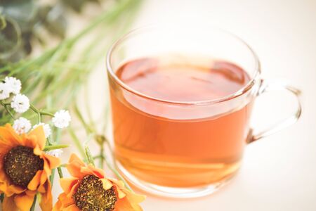 Autumn tea. Marigolds and tea cup autumn backgroundの写真素材