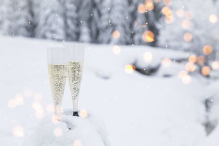 Champagne glasses in winter wonderland snowの写真素材