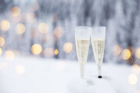 Champagne glasses in winter wonderland snowの写真素材