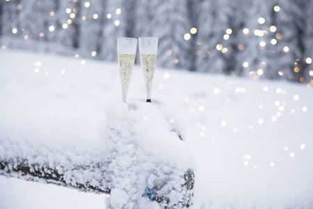 Champagne glasses in winter wonderland snowの写真素材