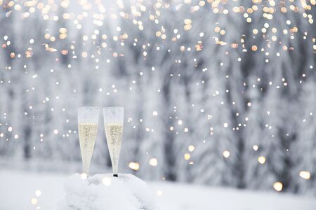 Champagne glasses in winter wonderland snowの写真素材