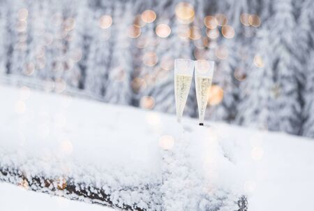 Champagne glasses in winter wonderland snowの写真素材