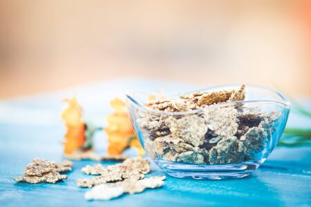 Organic cereal and forest berries on blue wooden backgroundの写真素材