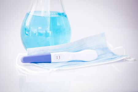 Positive pregnancy test in coronavirus pandemicの写真素材