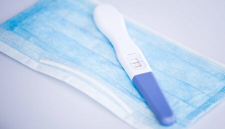 Positive pregnancy test in coronavirus pandemicの写真素材