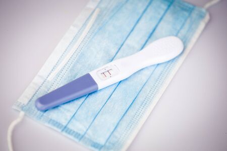 Positive pregnancy test in coronavirus pandemicの写真素材