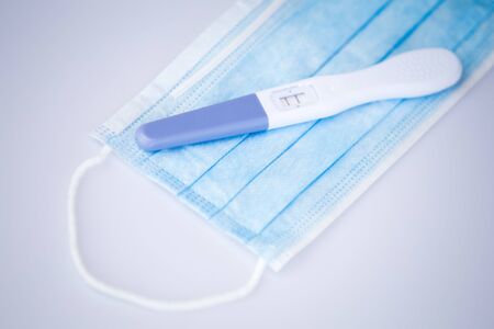 Positive pregnancy test in coronavirus pandemicの写真素材
