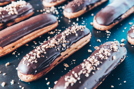 Traditional french eclairs with chocolate. Tasty dessert. Home made cake eclairs. Sweet Dessert Pastry filled with cream. Chocolate icing.の写真素材