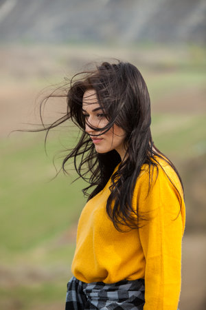Beauty fashion portrait of young beautiful brunette girl with long black hair and green eyes. Beauty portrait of female face with natural skin.の写真素材