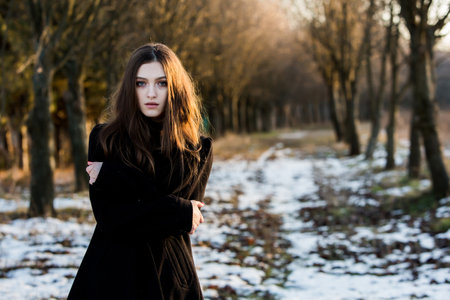 Portrait of a beautiful girl with flying hair in the wind. Young sad woman. Portrait of lonely womanの写真素材