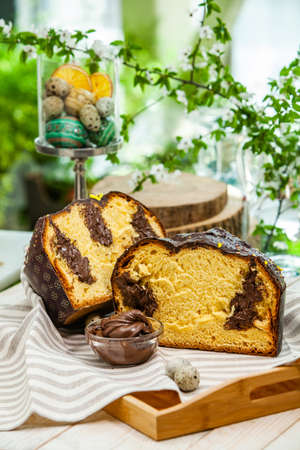 Panettone is the traditional Italian dessert for easter in 2021. Homemade panettone covered in chocolate and sprinkles. Bread served as dessert.の写真素材