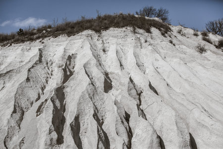 Abandoned limestone quarry. Interesting form of relief. Amazing hills and ground. Dry areas of the...