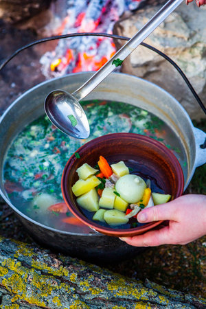 Cooking soup on a campfire. Selective focus. nature.の写真素材