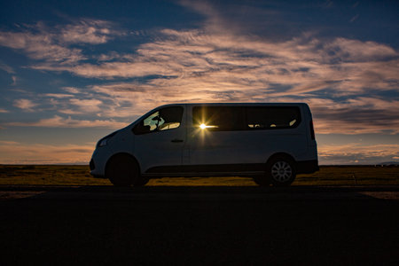 White van on the road at sunset in the desert of South Africaの写真素材
