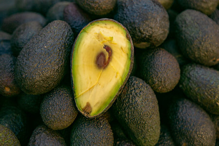 Avocado fruit on the market. Avocado background. Avocado close up.