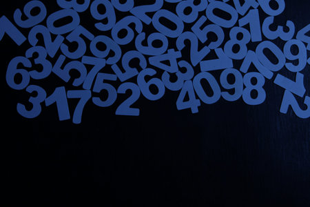 Blue numbers on a black wooden background with copy space for your text