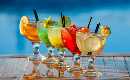 Variety of cocktails on the table at the swimming pool in summerの写真素材