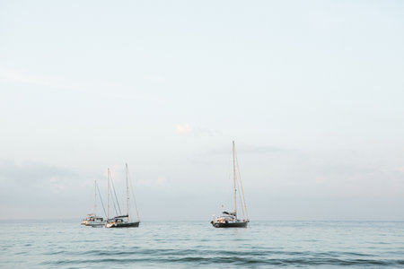Sailing boats in the sea at sunset. View from the sea.の写真素材