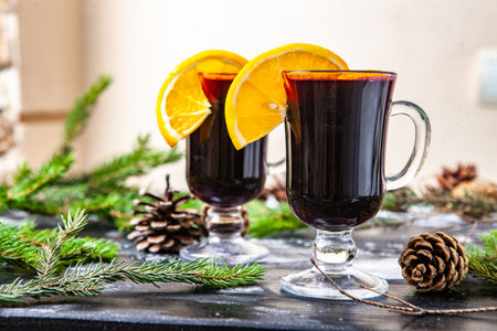 Mulled wine with orange and spices on a wooden background.の写真素材