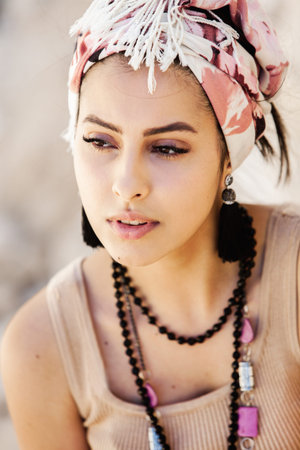 Portrait of a beautiful young hippie woman with headscarfの写真素材