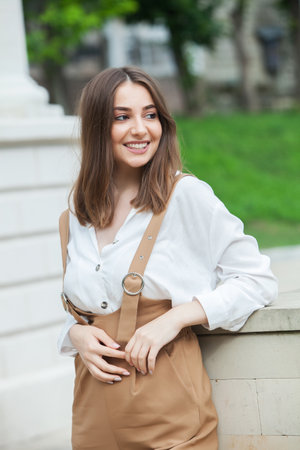 Portrait close up of young beautiful brunette woman, on summer streetの写真素材