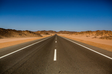 Road in the sahara desert of Egypt. Conceptual for freedom, enjoying the journey. Empty road. Freeway, Highway through the desertの写真素材