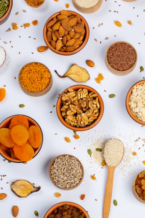 Healthy food background. Assortment of nuts, seeds and dried fruits on white background.の写真素材