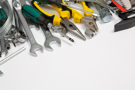 Assorted work tools on a white background with space for text.の写真素材