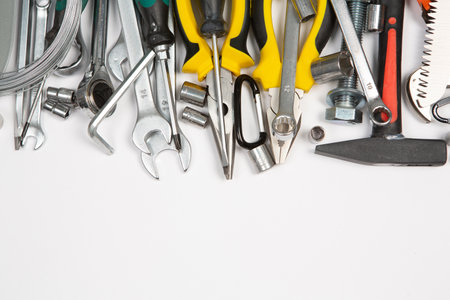 Variety of tools on white background. Top view with copy spaceの写真素材