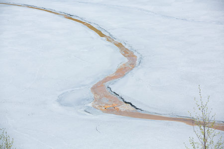Spring flood on the river. The river is covered with ice.