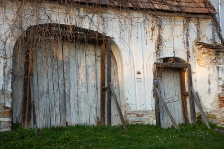 Old wooden door of an old abandoned farmhouse in the village.の写真素材