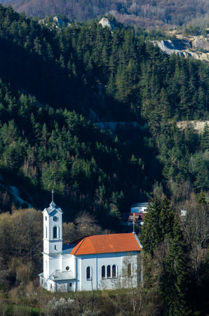 Church of St. John of Nepomuk on the background of mountainsの写真素材