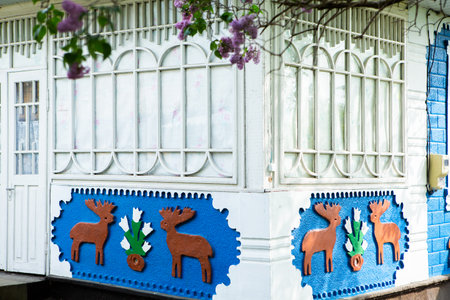 Colorful wooden door and window decorated with decorative reindeer.の写真素材