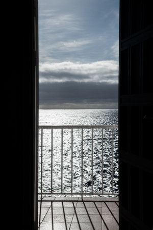 View of the sea through the open door to the sea and skyの写真素材