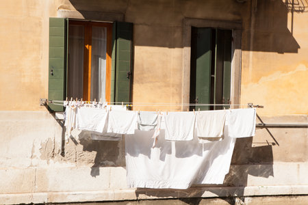 Clothes drying on a rope in the old town of Bologna, Italyの写真素材