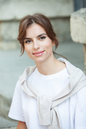portrait of a young beautiful brunette woman in a white T-shirt